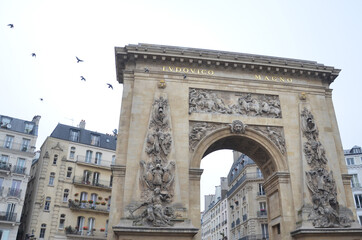 Fototapeta na wymiar La Porte Saint-Denis at Paris. This arch was also commissioned by King Louis XIV and it is very similar to La Port Saint Martin. 