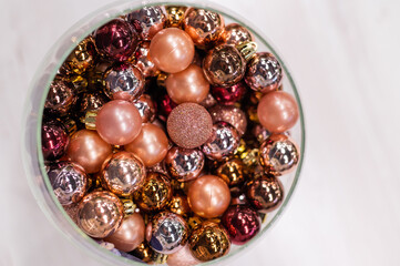 Shop counter with pink Christmas balls in a basket