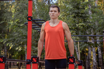 young athletic man goes in for sports in the park. outdoor fitness, healthy lifestyle