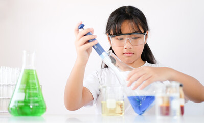 Asian girl doing experiments in the laboratory. Science and education.