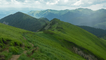 Hazy, rainy atmosphere on the high altitude pastures of Ciucas Mountains. The inclined, steep, mountain crests are covered with heavy rain. Carpathia, Romania.