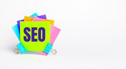 There are bright multi-colored stickers with the text SEO Search Engine Optimization. Copy space