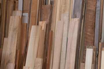 Fototapeta na wymiar Variety of boards in a woodshop ready to be used to make furniture