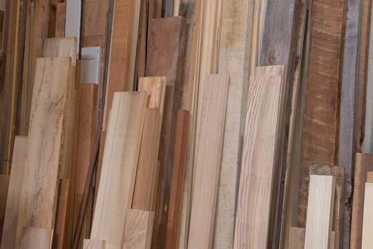 Variety of boards in a woodshop ready to be used to make furniture
