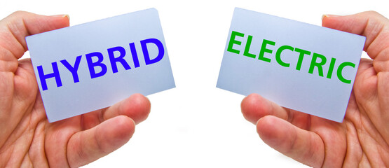 man hands holding cardstocks with the words hybrid and electrical.