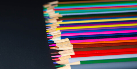 pencil row on black background
