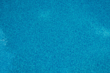 The colorful blue bottom of an inground pool as a background or backdrop