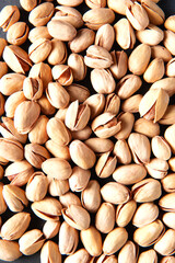 Scattered pistachio nuts. Background. Selective focus. Close-up.