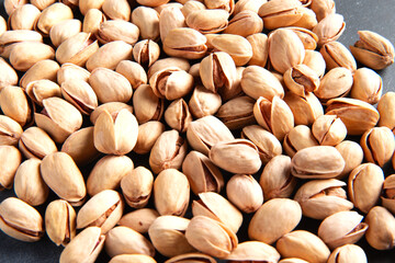Scattered pistachio nuts. Background. Selective focus. Close-up.
