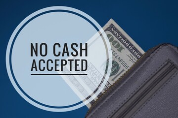 A phrase of NO CASH ACCEPTED with at the background a money in a wallet isolated in blue background. Cashless concept.