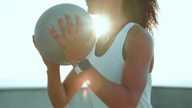 A Close-up View Of An African American Woman Doing Squats With Weight Outside