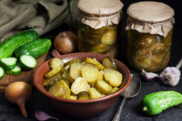Pickled cucumber salad in a bowl and jars