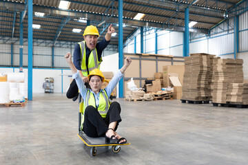 factory workers moving cart and funny pose in warehouse storage