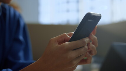 Businesswoman texting message on smartphone. Female worker using mobile phone