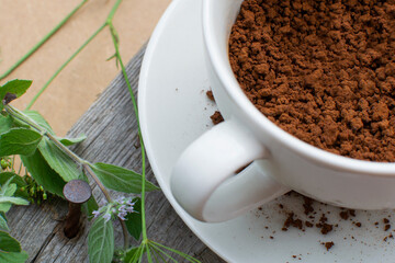 Composition: Herbs and instant coffee in a porcelain cup. 