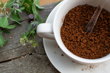 Composition: Herbs and instant coffee in a porcelain cup. 