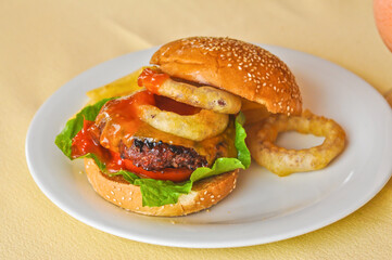 Beef burger served with Onion rings
