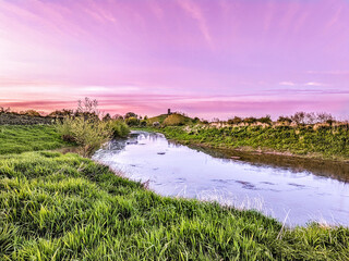 Sunset over the tidal River Parret in Somerset, UK.