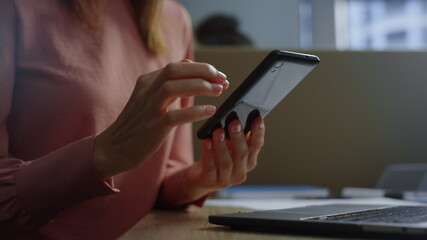 Businesswoman hands using touchpad on smartphone screen. Woman texting message