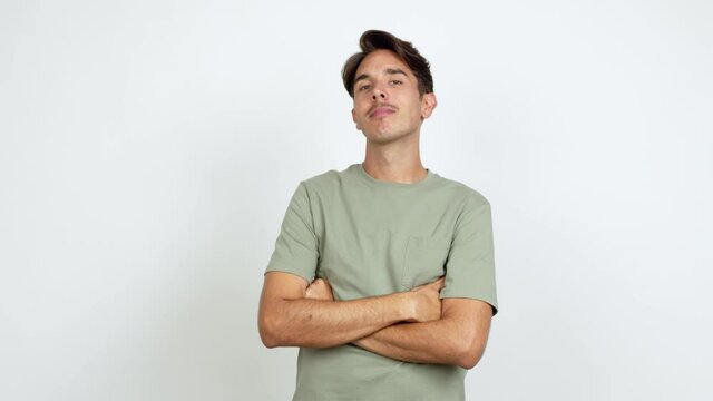Young man keeping the arms crossed in confident expression over isolated background