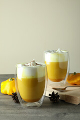 Concept of pumpkin latte on gray textured table