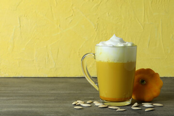 Concept of pumpkin latte on gray textured table