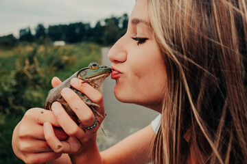 girl kissing a frog 