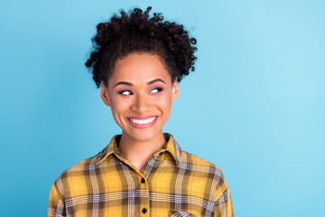 Photo of young cheerful afro woman happy positive smile curious look empty space dream isolated over blue color background