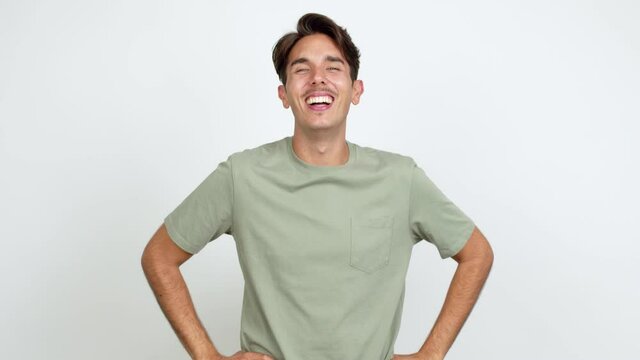 Young man smiling a lot while covering mouth over isolated background
