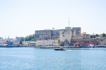 Fototapeta premium destroyer moored in the port of the ancient city of brindisi near the fortress Swabian Castle