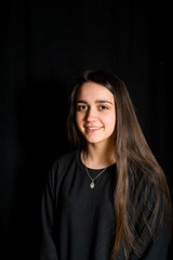 portrait of teenage girl with black background -smiling girl with long hair portrait-