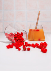 Fresh goji berries in a transparent glass and fresh berry juice.