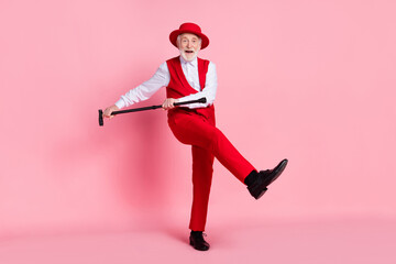 Fototapeta na wymiar Full size photo of aged cheerful man happy positive smile dance party stick isolated over pink color background