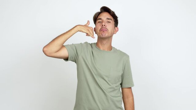 Young man making phone gesture and speaking with someone. Call me back sign over isolated background