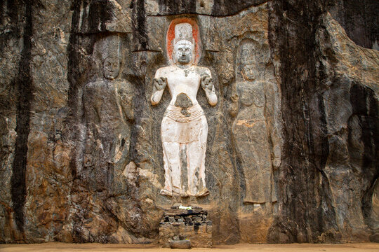 Antique Buddha reliefs carved out on the rock in Buduruwagala, Sri Lanka