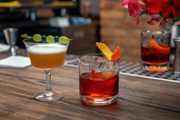 Tasty long drink on bar counter. Two cocktails, drinks for man and woman, a romantic date at the bar.