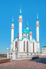 Beautiful white mosque with a blue roof against the blue sky.