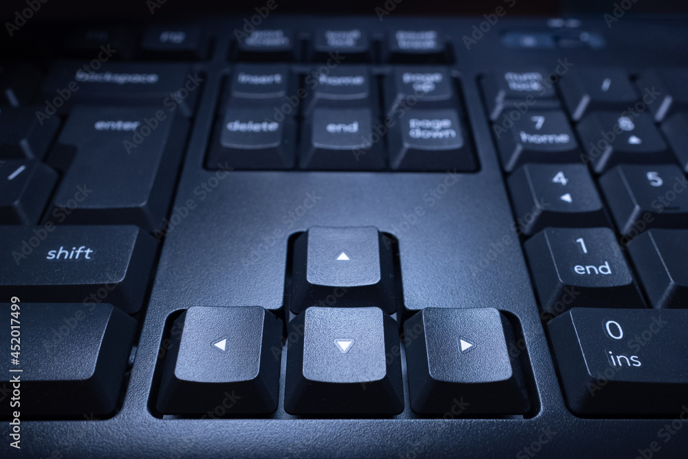 Poster arrow keys on the computer keyboard. black buttons up, down, left and right. close-up of the keyboar