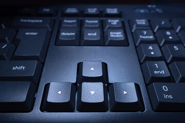 Arrow keys on the computer keyboard. Black buttons up, down, left and right. close-up of the...
