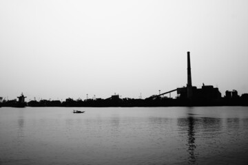 Fototapeta na wymiar Ganges river in black and white with Industrial background, High contrast image.