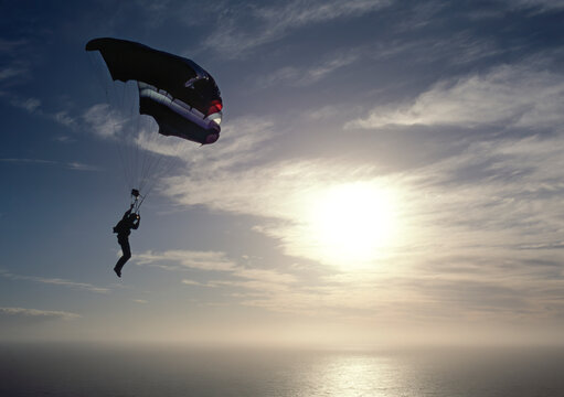 Paraglider in cloudy winter sky