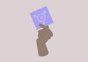 A hand holding a note with a gender equality symbol on it