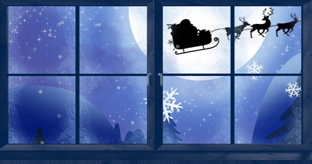 Obraz premium Image of black silhouette on santa claus in sleigh being pulled by reindeer with winter scenery 