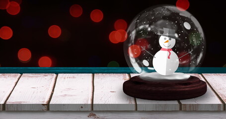Image of snow globe with snowman with flickering christmas red fairy lights on black background