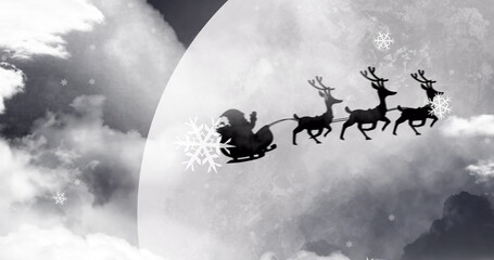 Obraz premium Image of black silhouette on santa claus in sleigh being pulled by reindeer with winter scenery 