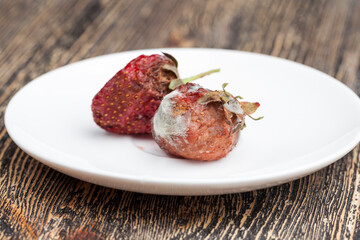 moldy rotting red strawberries close up