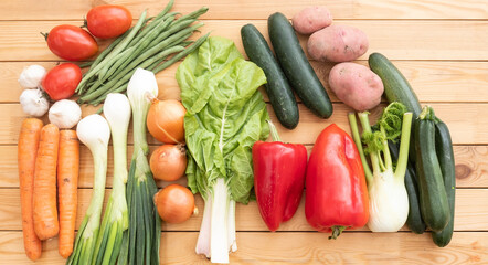Group of assorted raw organic vegetables on a wooden table. Vegan, vegetarian detox diet