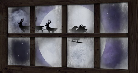 Image of silhouette of santa claus in sleigh being pulled by reindeer and winter christmas scene