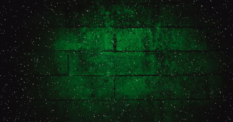 Image of winter scenery snow falling against green brick wall