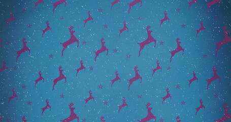 Image of snow falling against christmas reindeer pattern on blue